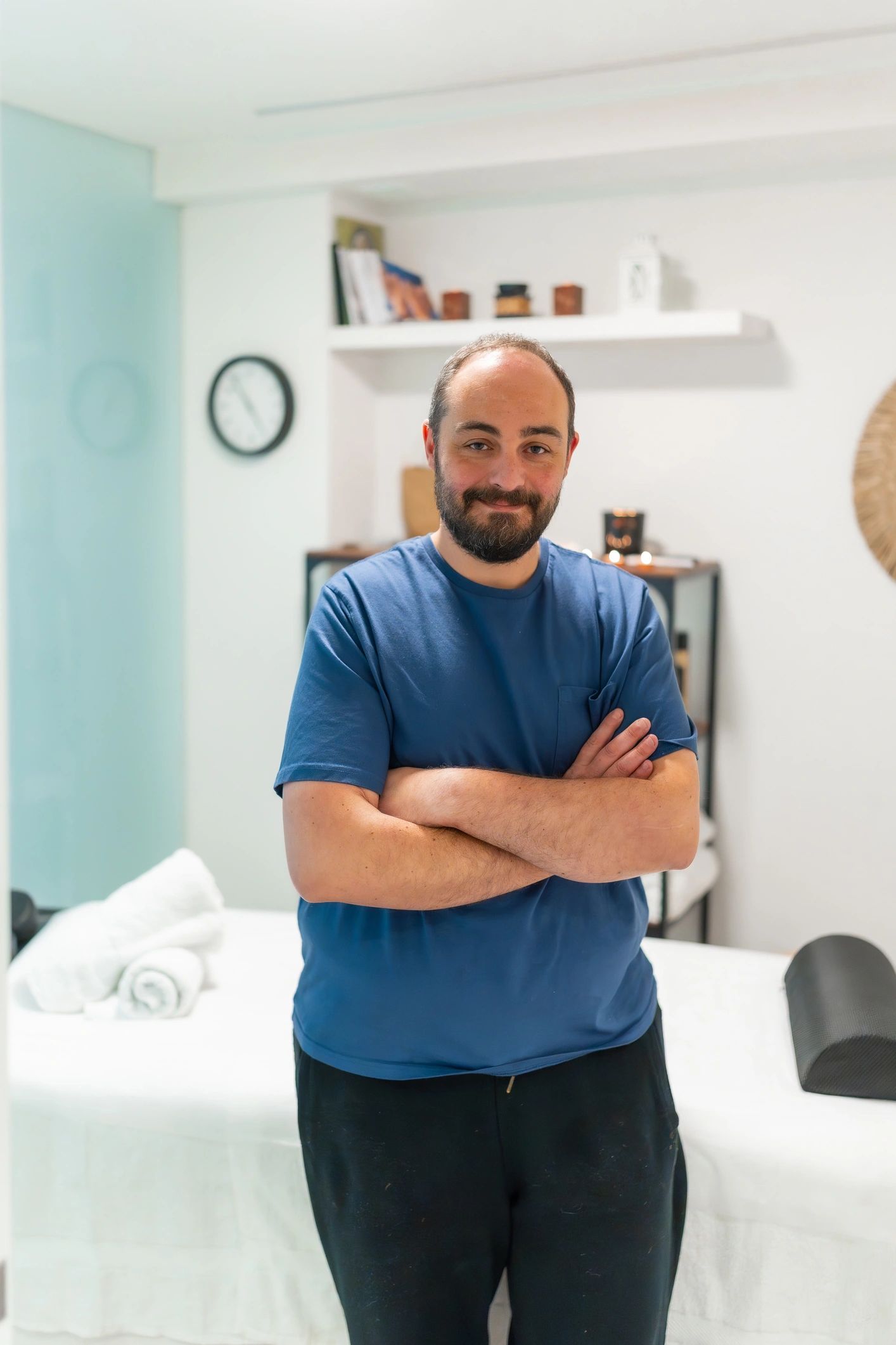 Male massage therapist standing in a modern wellness clinic